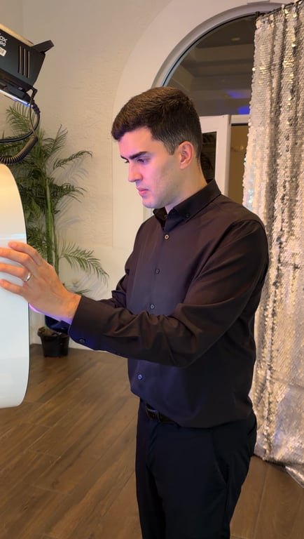 Gabe setting up a photo booth at an evening event