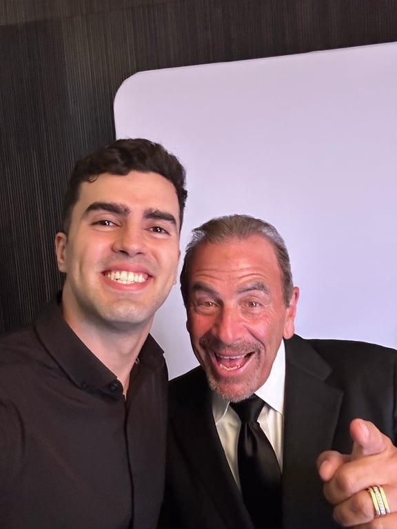 Gabe taking a selfie with a smiling guest at an event